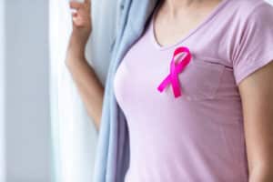 half cropped woman wearing a pink shirt with pink ribbon in the chest part