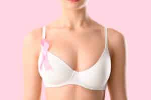 Young,Woman,In,Bra,And,With,Awareness,Ribbon,On,Pink